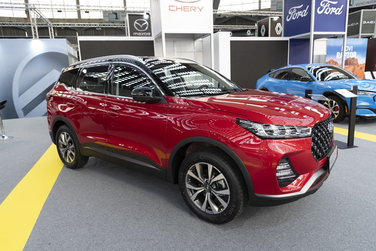 Front side view of red SUV with alloy wheels