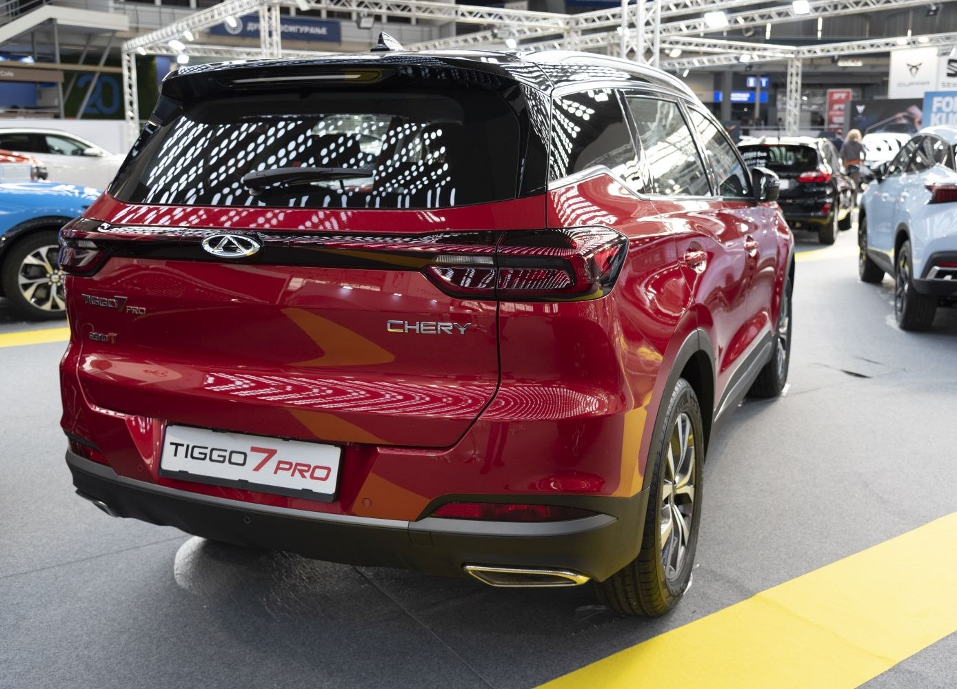 Rear view of red SUV with sleek tail lights and dual exhausts.