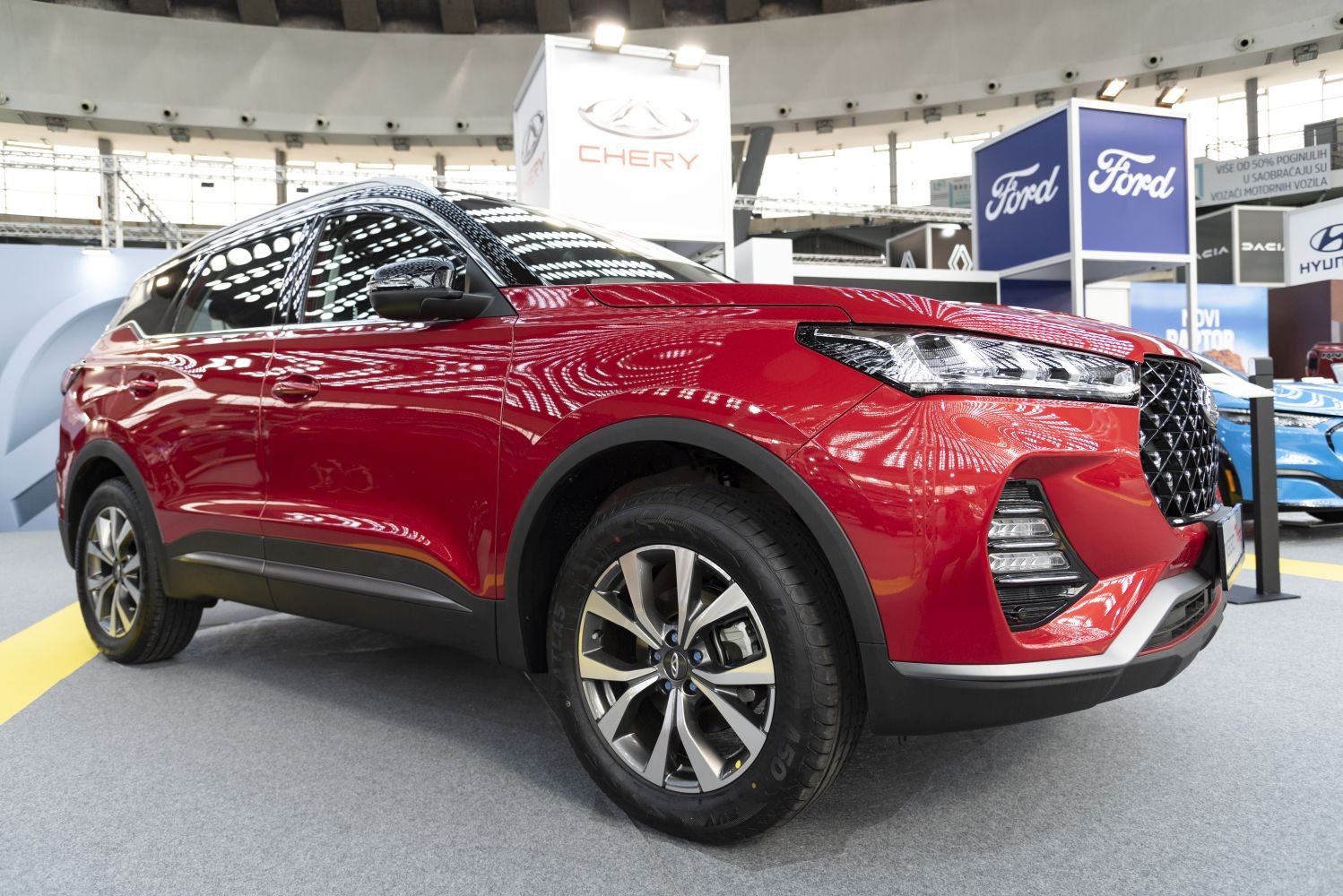 Front-side view of red SUV with LED headlights and alloy wheels