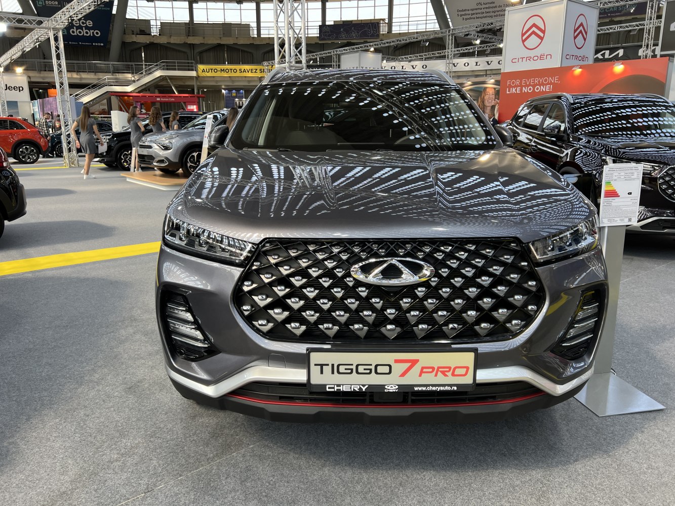 Front view of car with diamond-pattern grille and sleek headlights