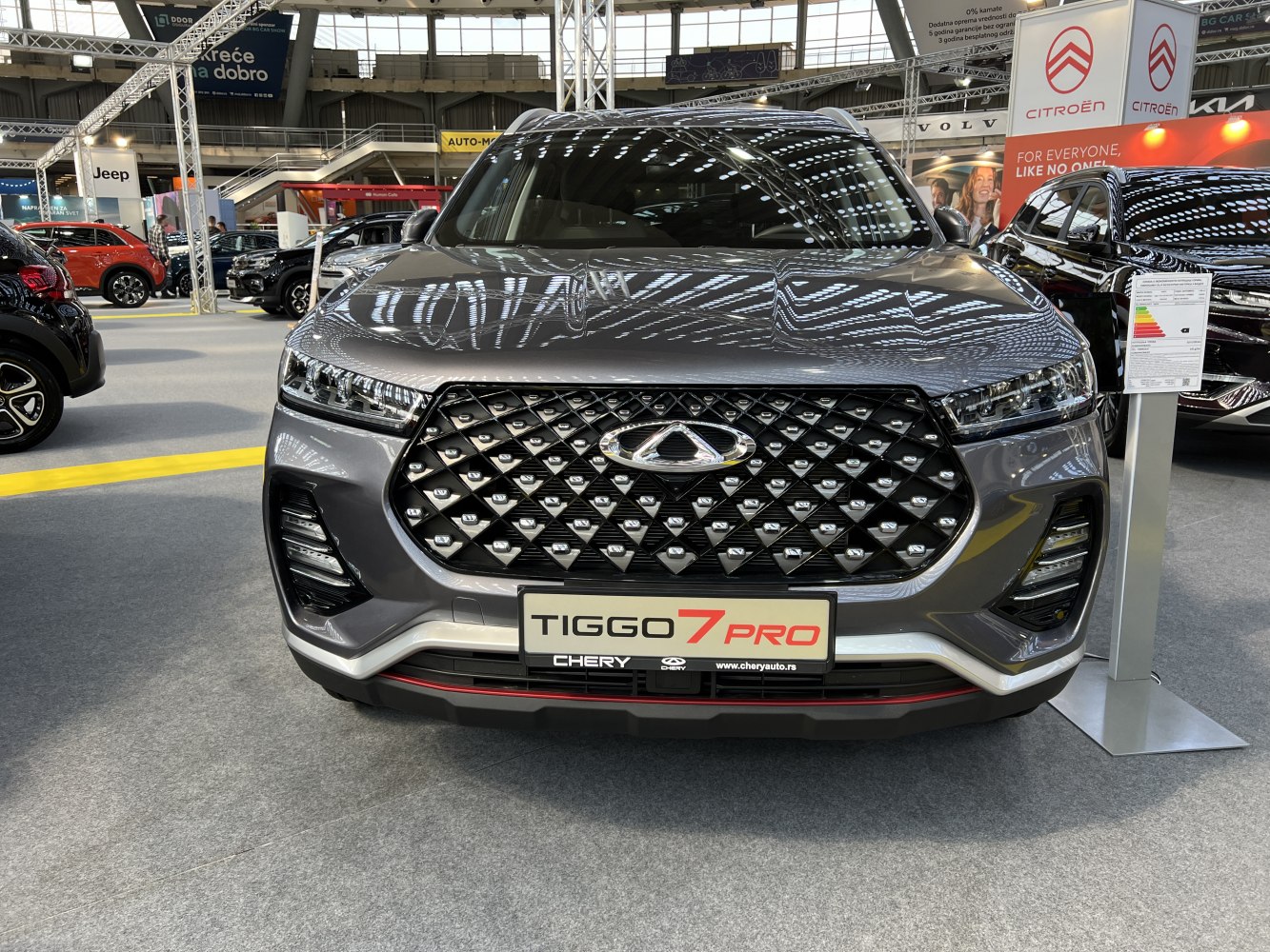 Prominent diamond-pattern grille and sleek LED headlights at front view.