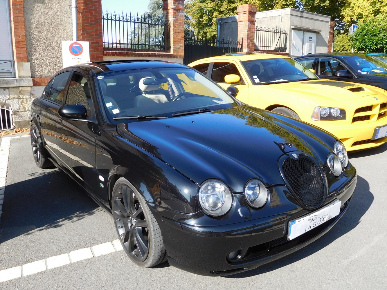 Black sedan with quad round headlights and black alloy wheels