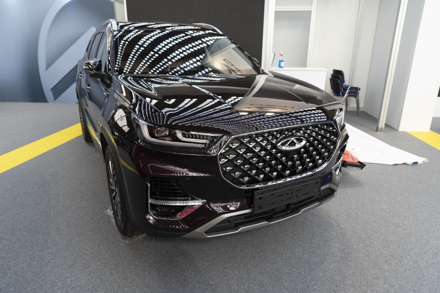 Front grille and headlight design of a modern SUV with diamond pattern grille