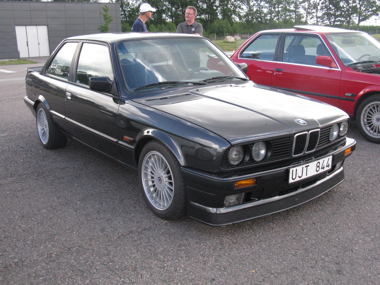 Black coupe with Alpina multi-spoke wheels and front spoiler