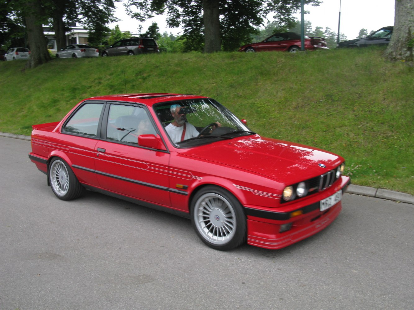 Red vintage sports sedan with alloy wheels and sunroof