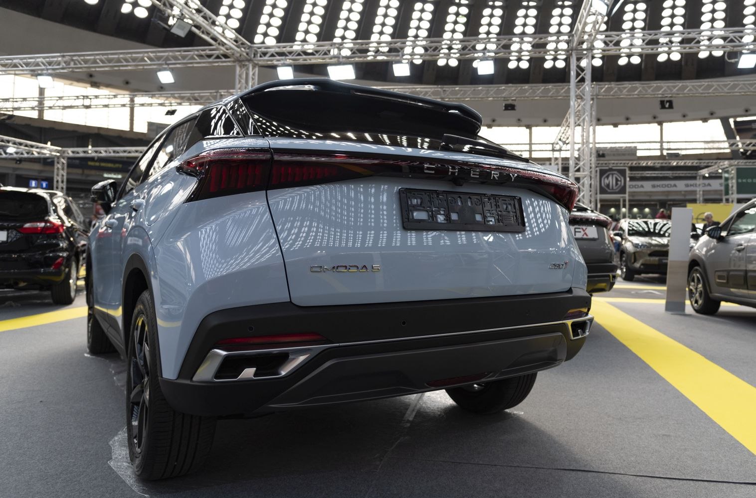 Rear view with LED tail lights, dual exhaust, and rear spoiler