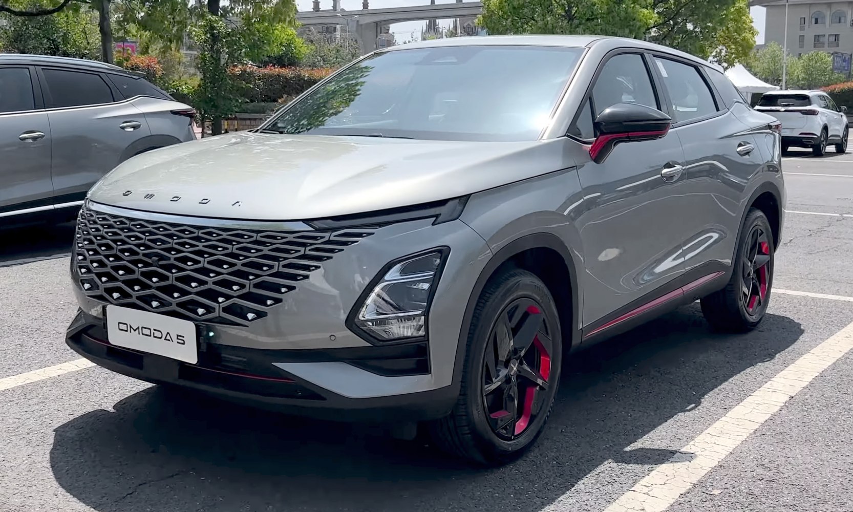 Unique geometric front grille and black alloy wheels with red accents.