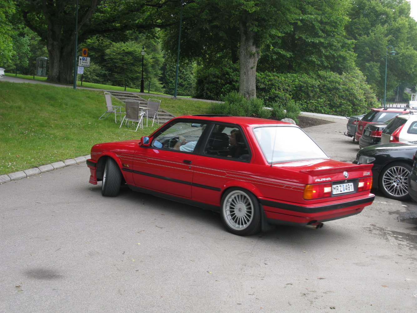 Classic red vintage sports coupe with distinctive rear and sporty wheels.
