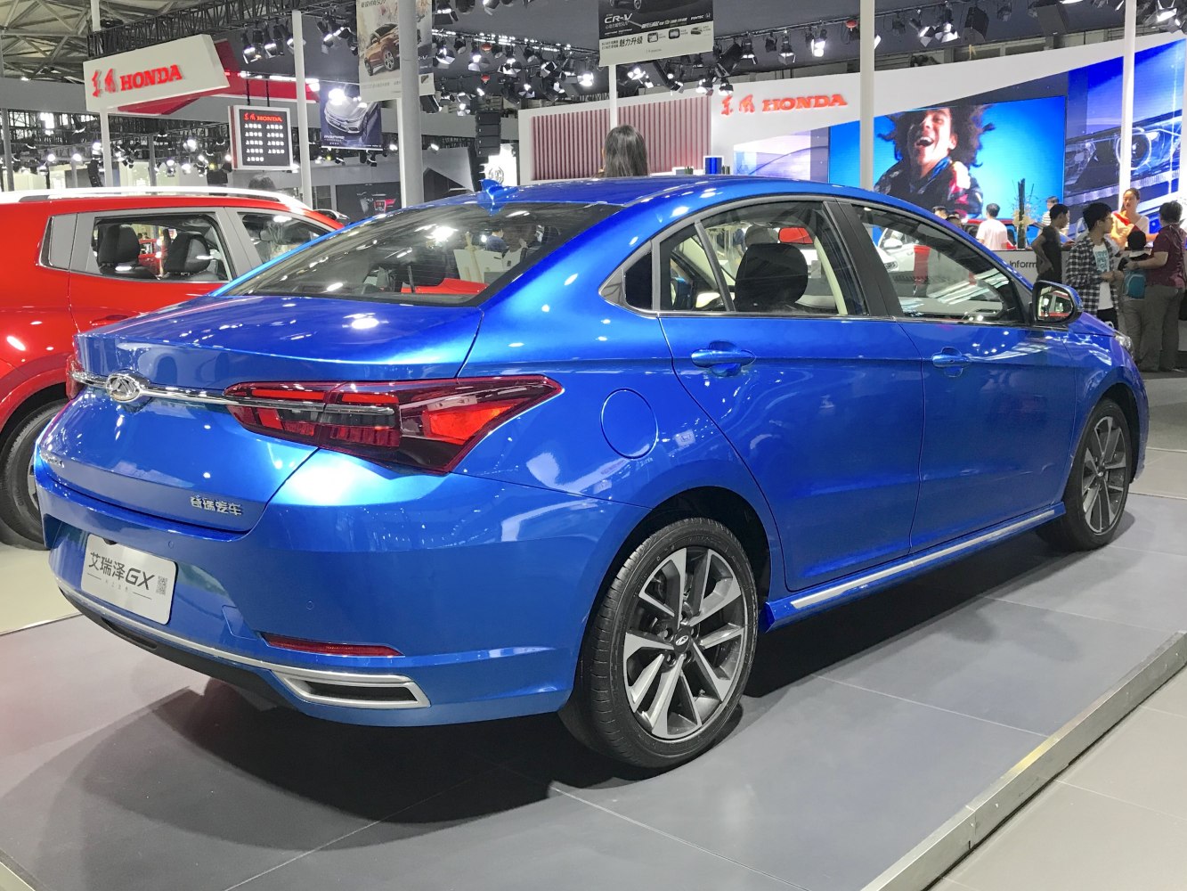 Blue sedan rear and side view with alloy wheels and modern tail lights
