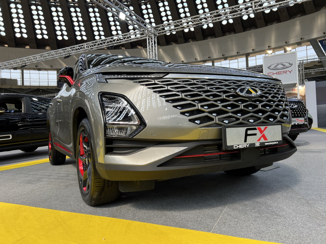 Modern front grille and dynamic headlights with red-accented wheels