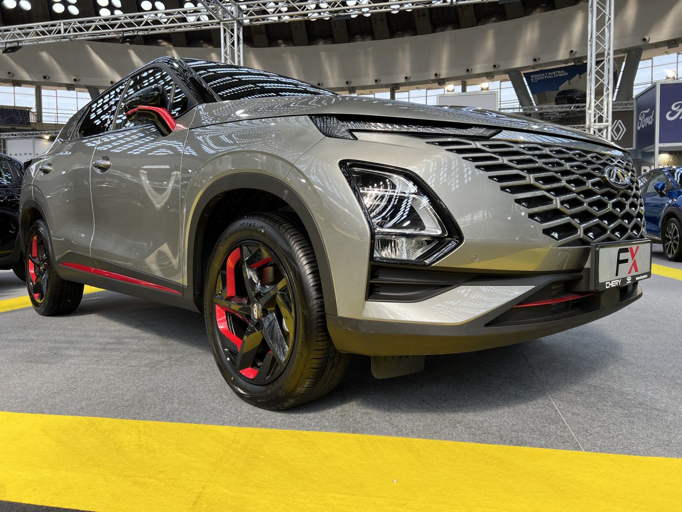 Bold front grille, LED headlights, sporty red-accented rims