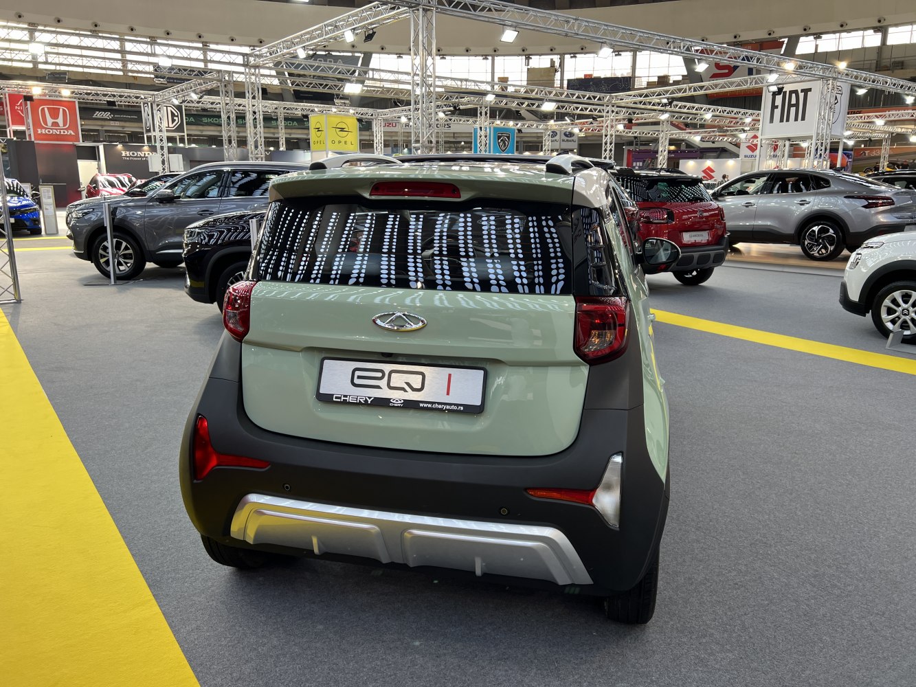 Compact electric vehicle rear view with taillights and design details