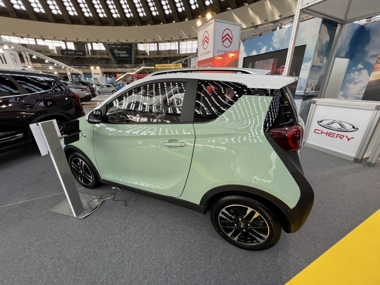 Compact electric city car side profile with two-tone paint and alloy wheels