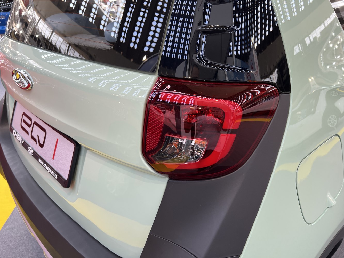 Close-up of rear light and tailgate design with black panel and smooth paint finish.