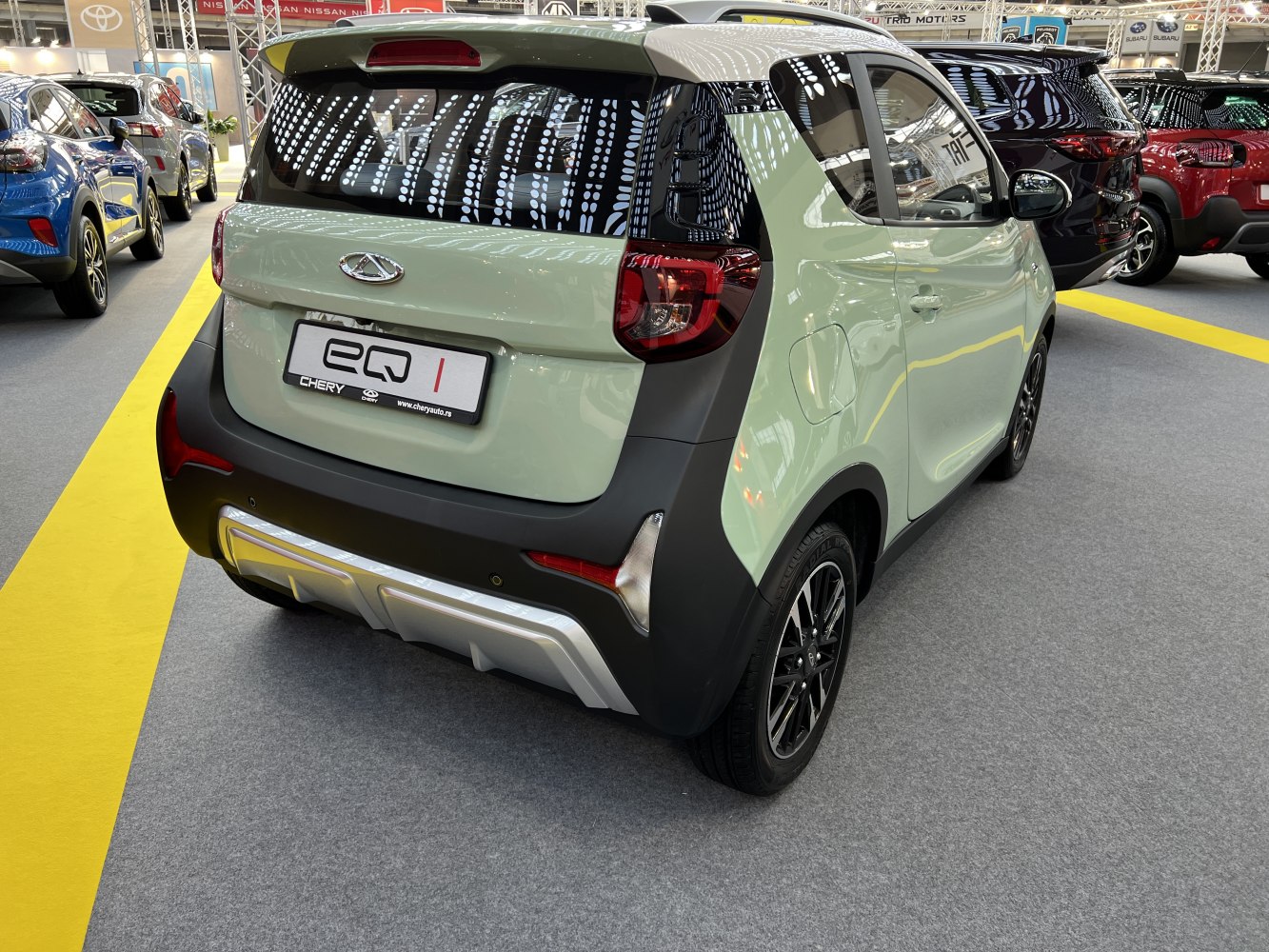 Compact electric vehicle rear design with distinctive taillights and sporty bumper