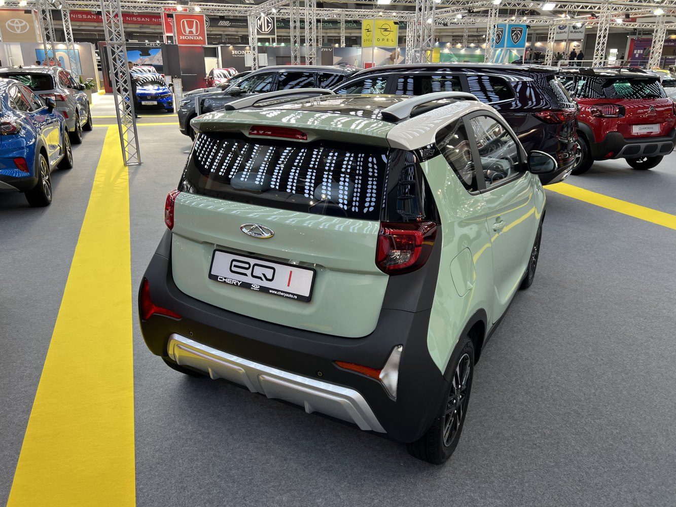 Rear view of compact electric city car with distinctive taillights and two-tone paint