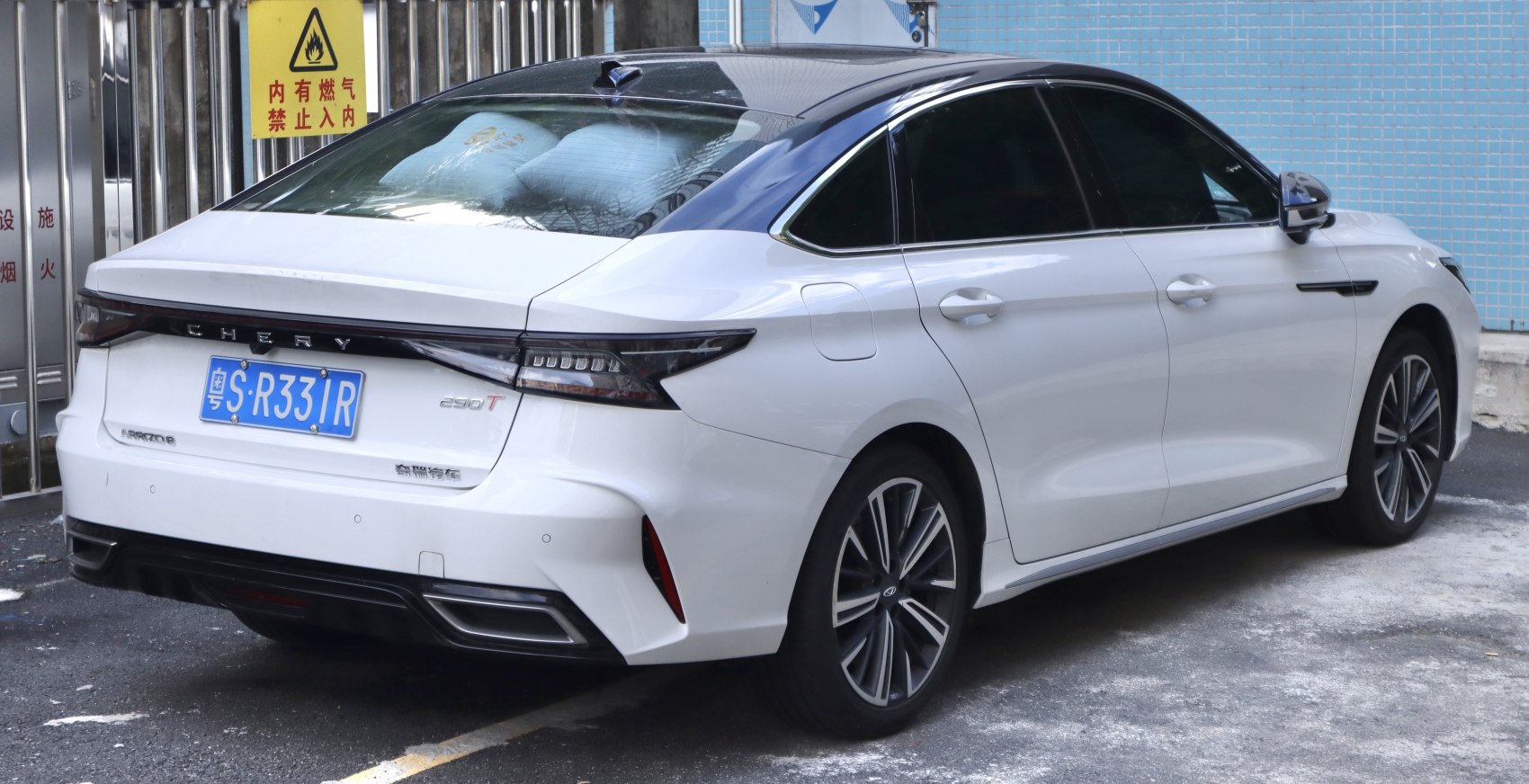 Rear view of a modern sedan with sleek LED taillights and alloy wheels