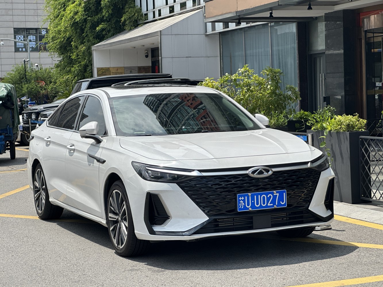 Modern sedan front with large black grille and sleek LED headlights