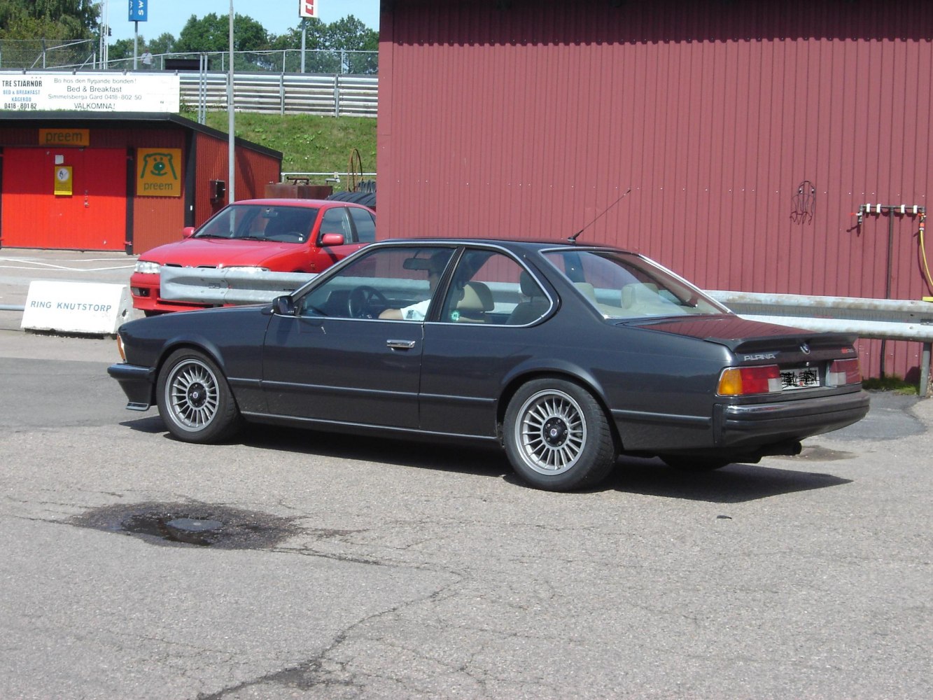 Vintage coupe with multi-spoke alloy wheels and subtle rear spoiler