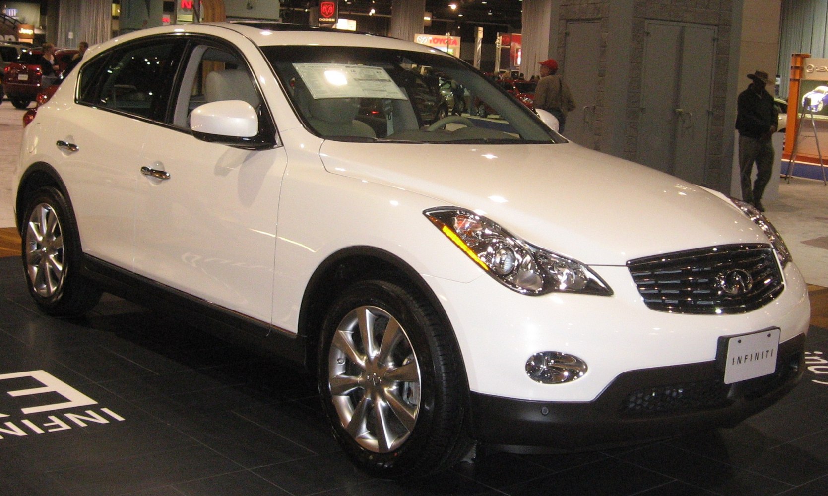 Front side view with sleek headlights and bold grille.