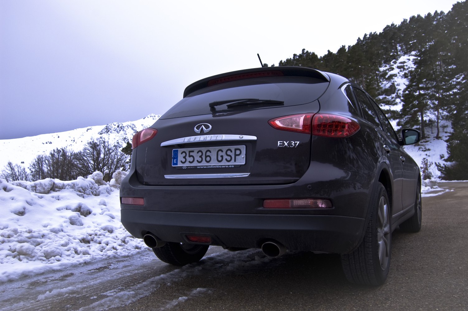 Rear view of black SUV with dual exhaust and distinct tail lights.