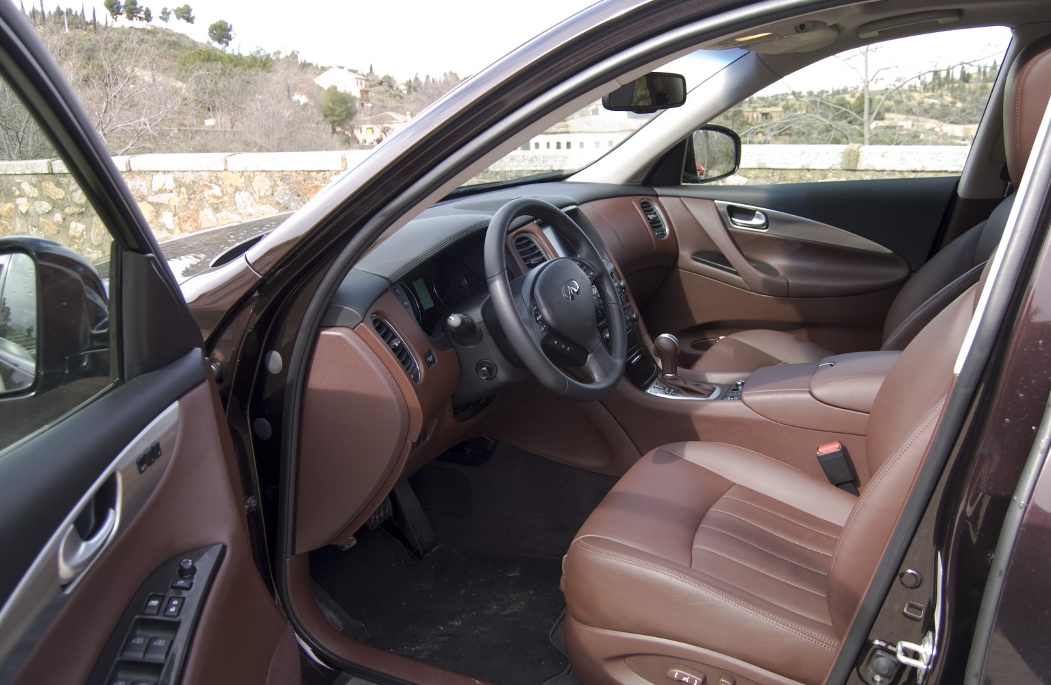 Brown leather interior with modern steering wheel and dashboard