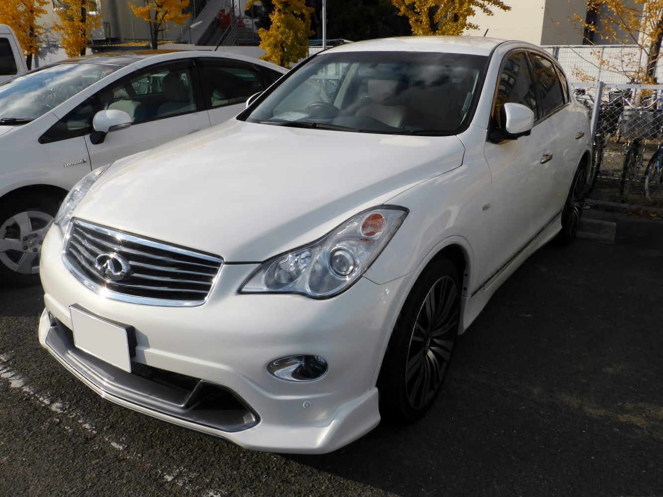 White luxury sedan with chrome grille and alloy wheels.