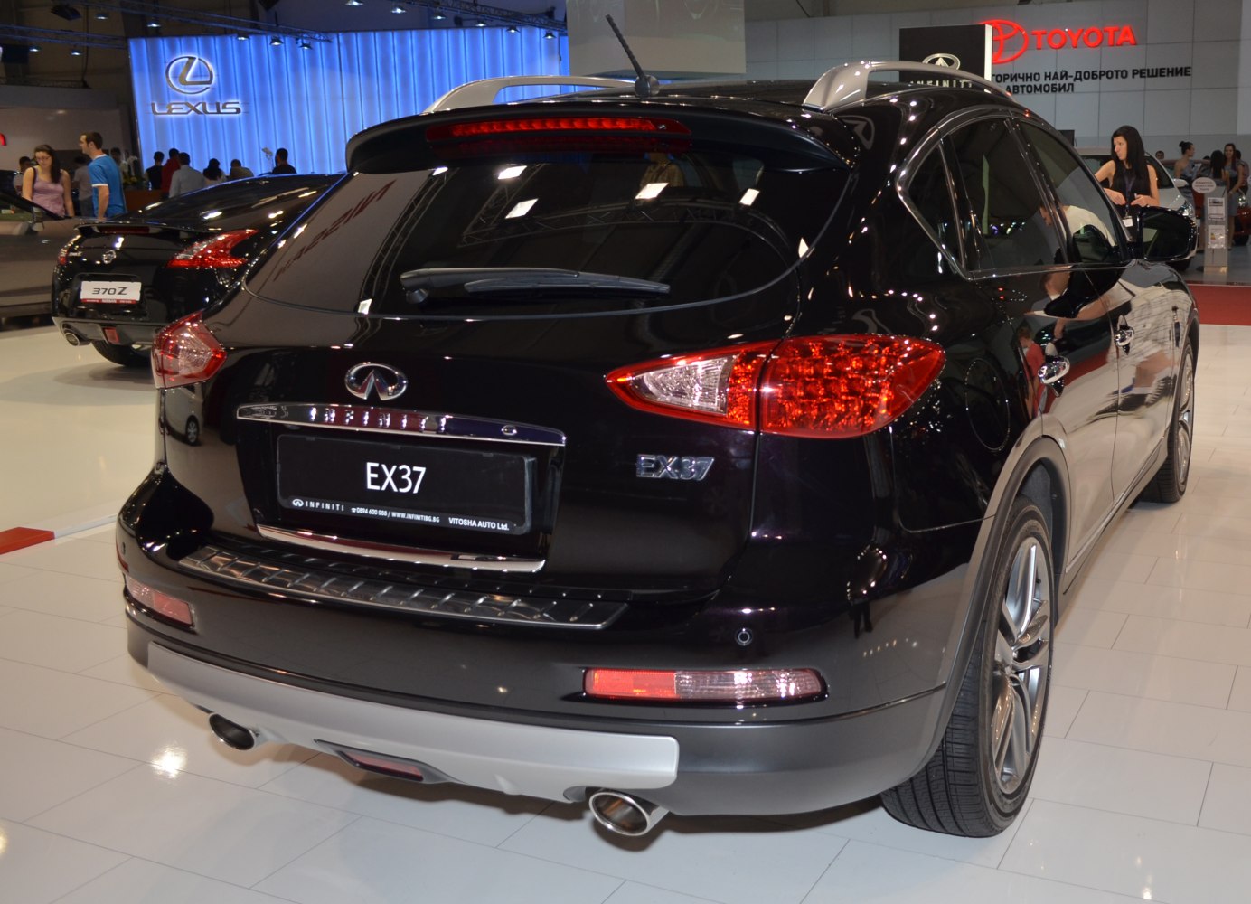 Rear view of a black SUV showing taillights, rear window wiper, and dual exhaust
