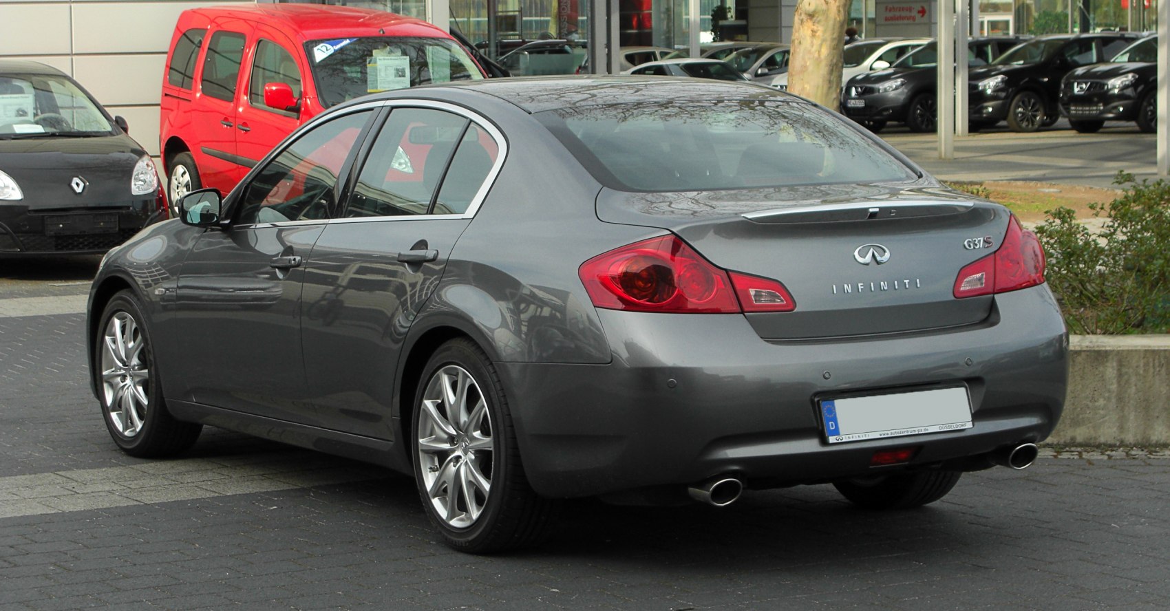 Rear view with taillights and dual exhaust of a sedan.