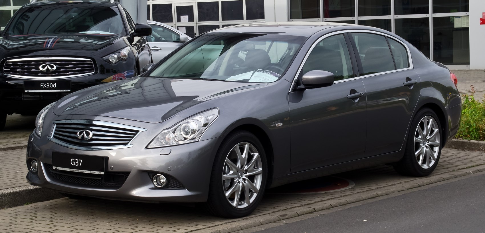 Gray Infiniti G37 Sedan with signature grille and alloy wheels
