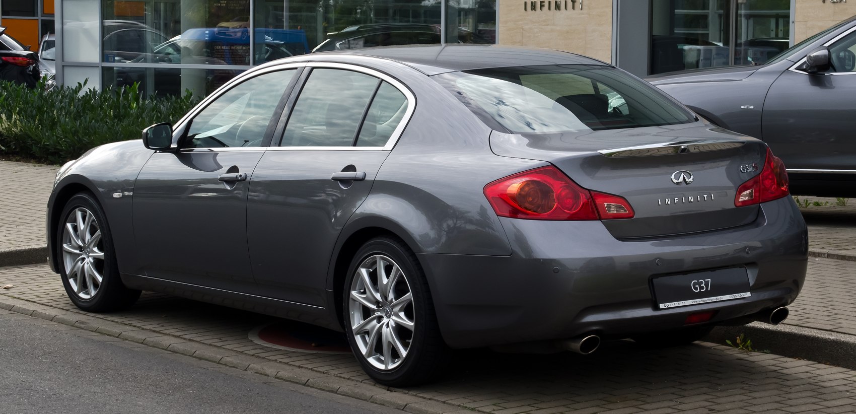 Rear and side profile of a sedan with red taillights and alloy wheels