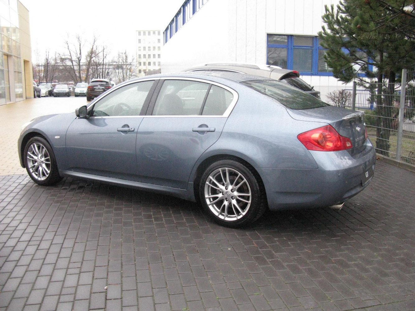 Sedan side and rear view with alloy wheels and rear spoiler