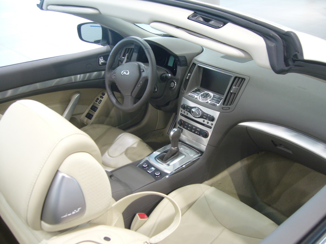 Beige leather seats, steering wheel, and center console with infotainment system