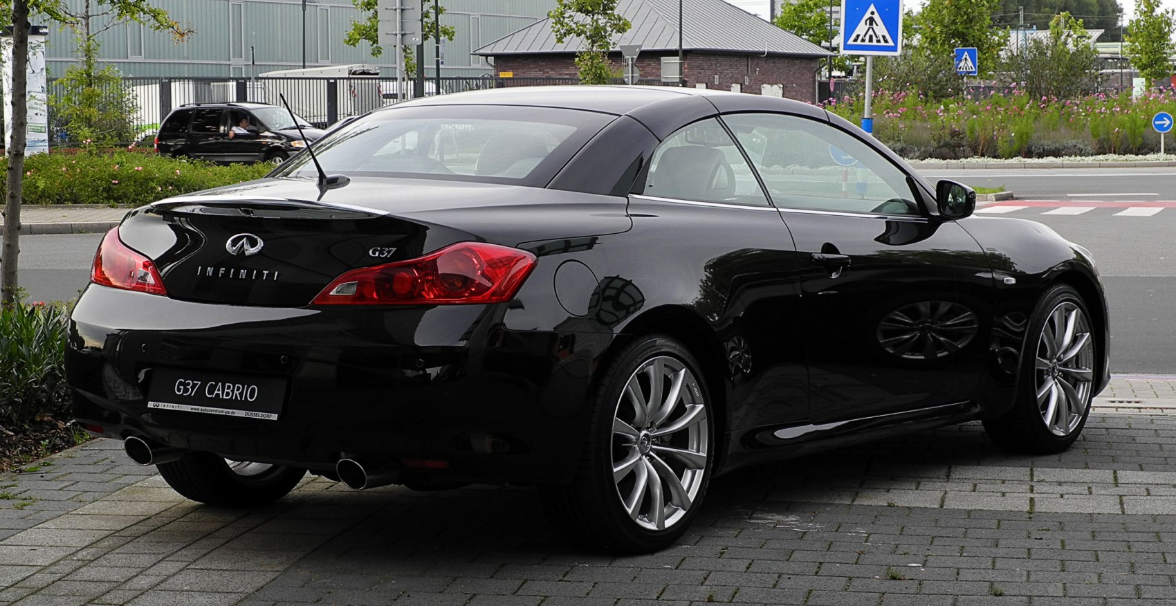 Rear view of convertible coupe with dual exhaust and alloy wheels