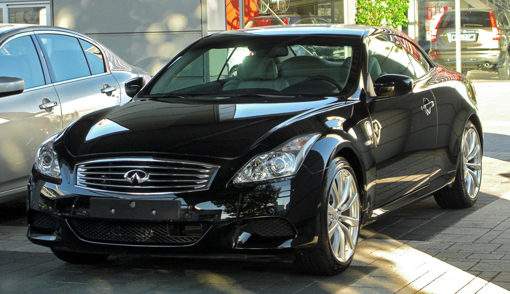 Front view of luxury coupe with chrome grille and alloy wheels