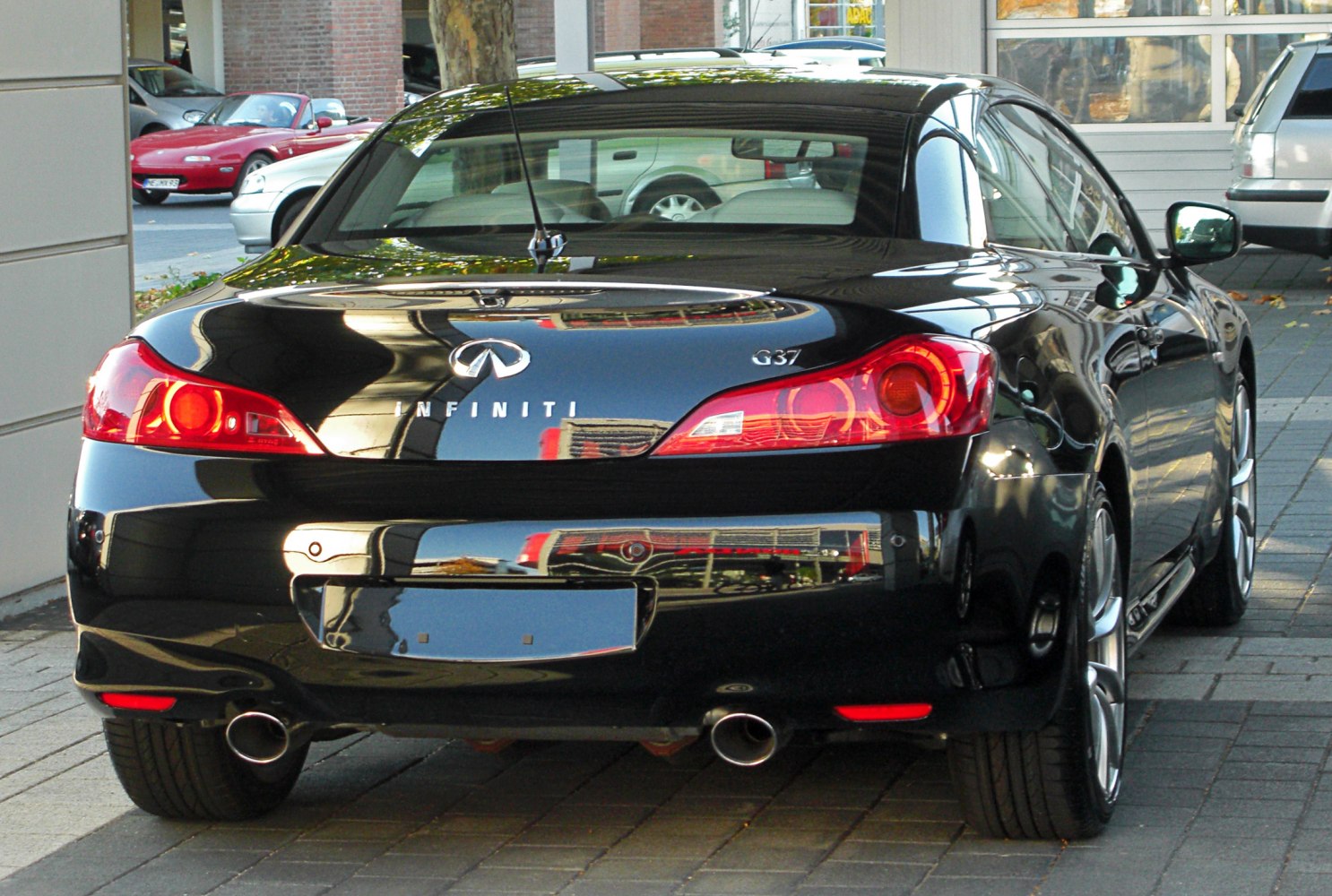Rear view of sports convertible with dual exhaust and distinct tail lights