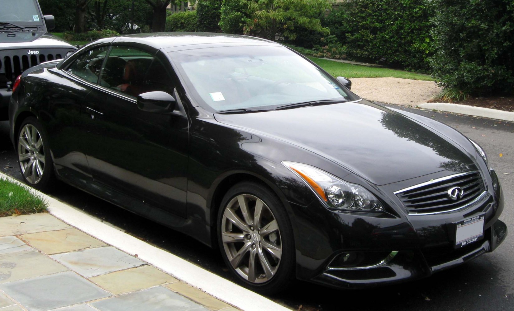 Front-side view of a sleek convertible with alloy wheels and clear headlights