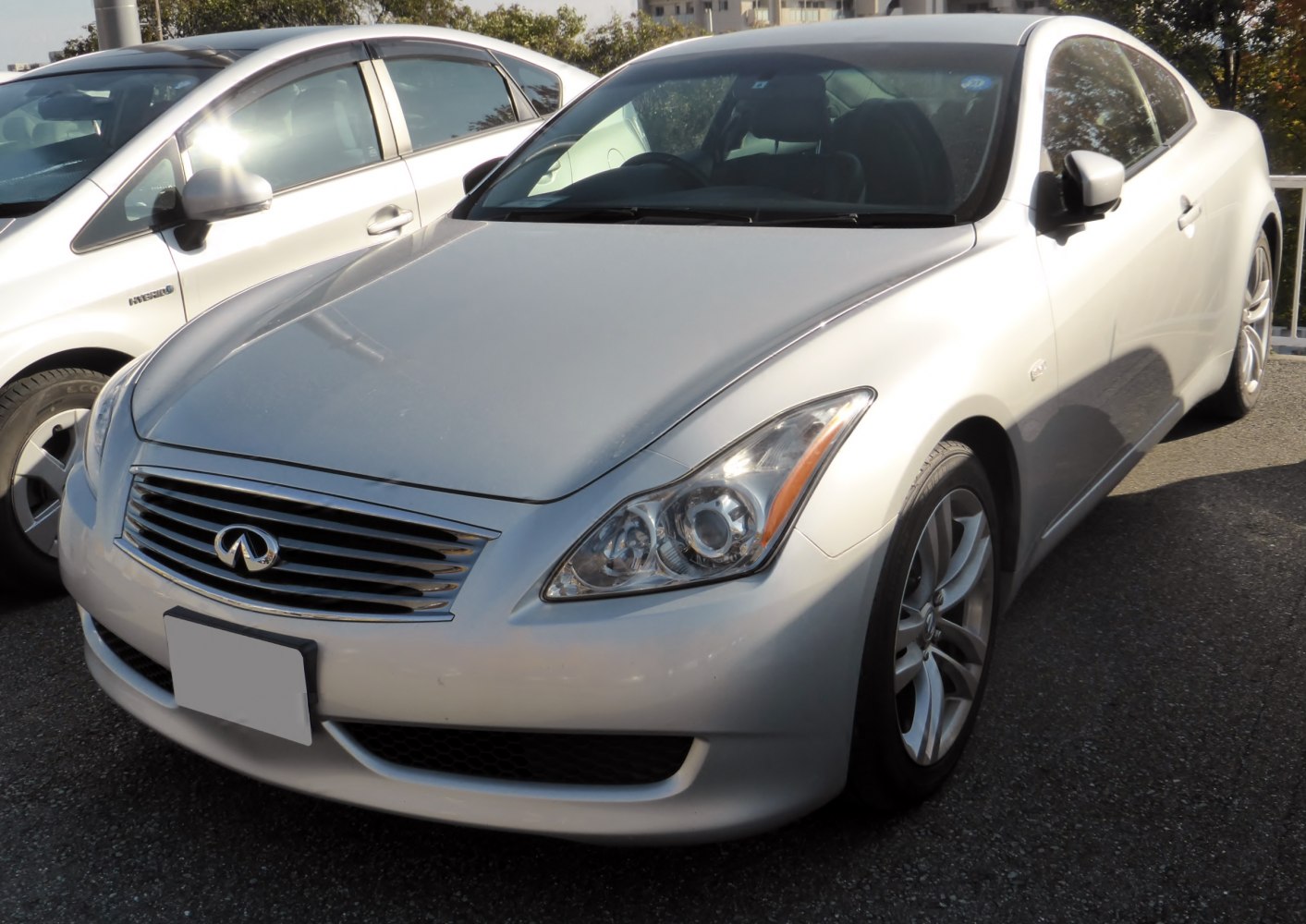 Front view of silver sports coupe with distinctive headlights and chrome grille