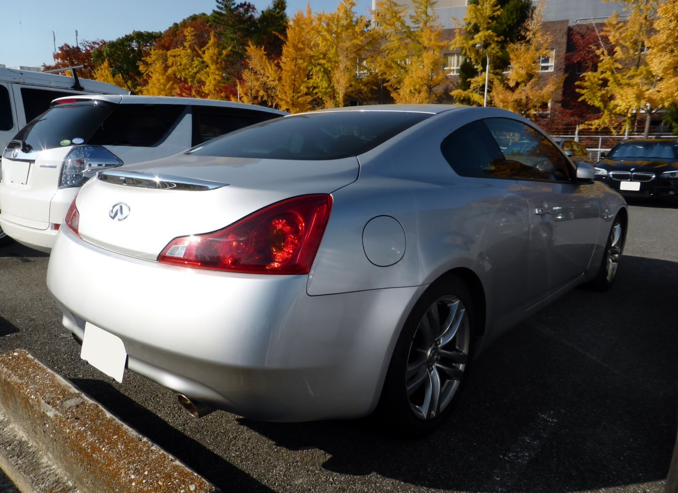 Silver sports coupe rear with red taillights and alloy wheels
