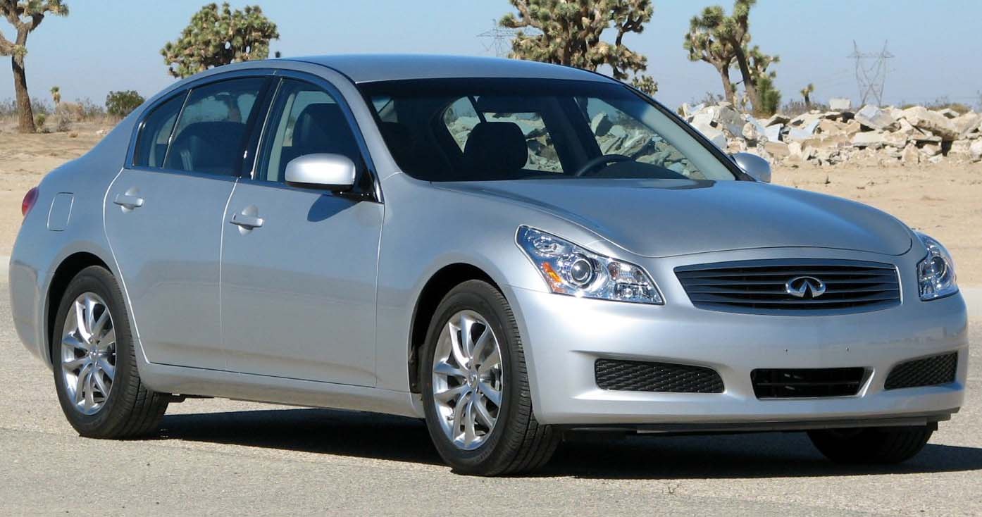 Silver sedan front side with headlights, grille, and alloy wheels