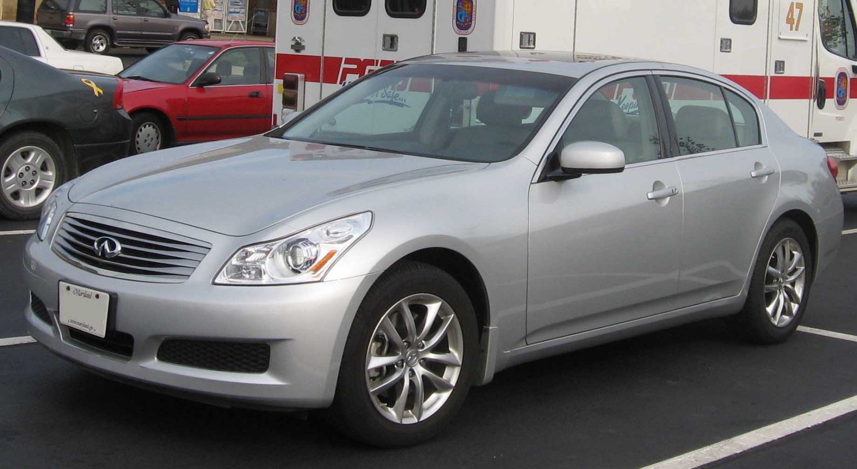Silver sedan, front grille, alloy wheels