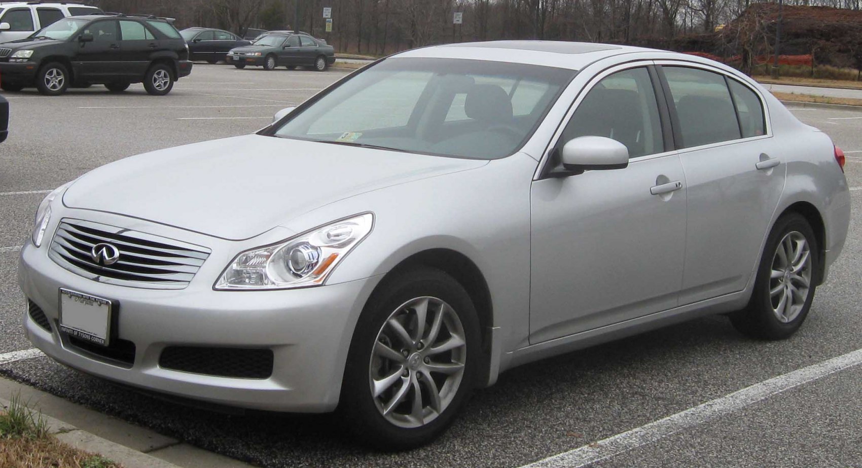 Silver luxury sedan front-side view with distinctive headlights and grille