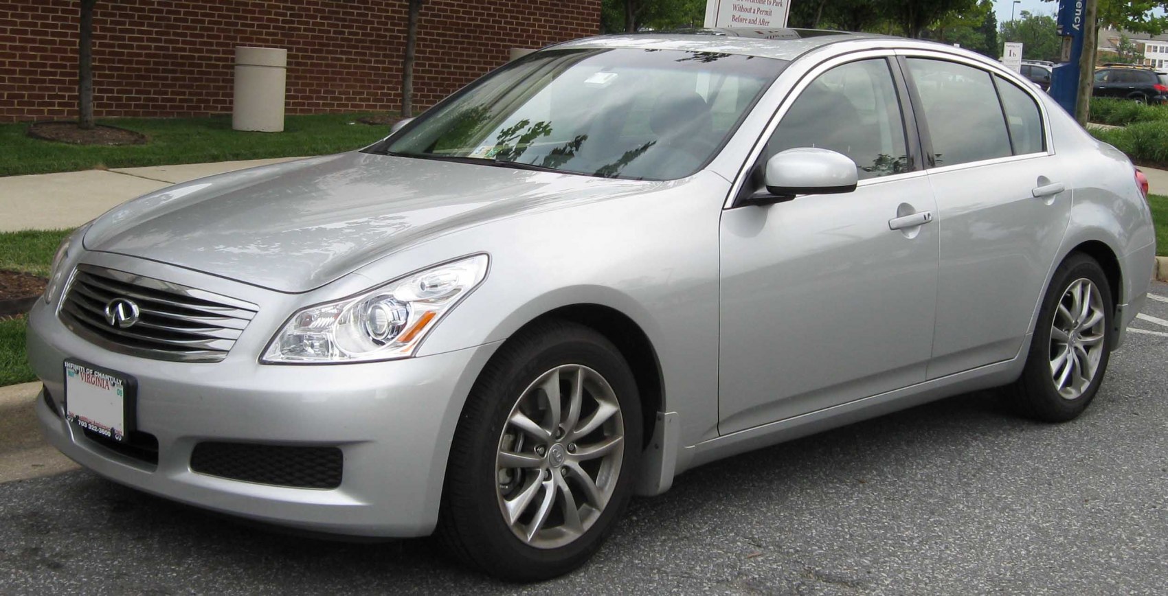 Silver luxury sedan front-side view with alloy wheels and sleek headlights