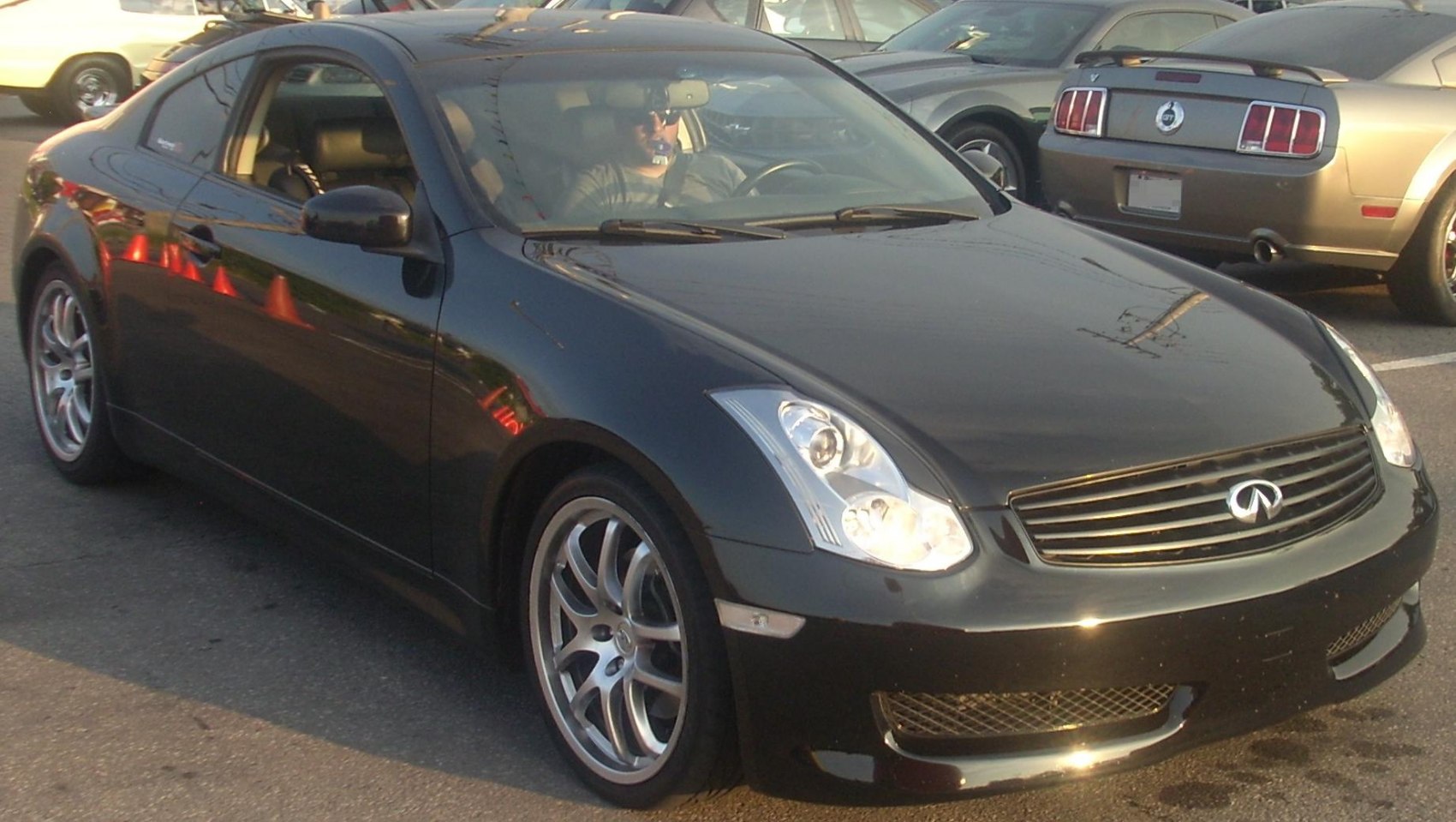 Front side view of sleek coupe with distinctive grille and alloy wheels