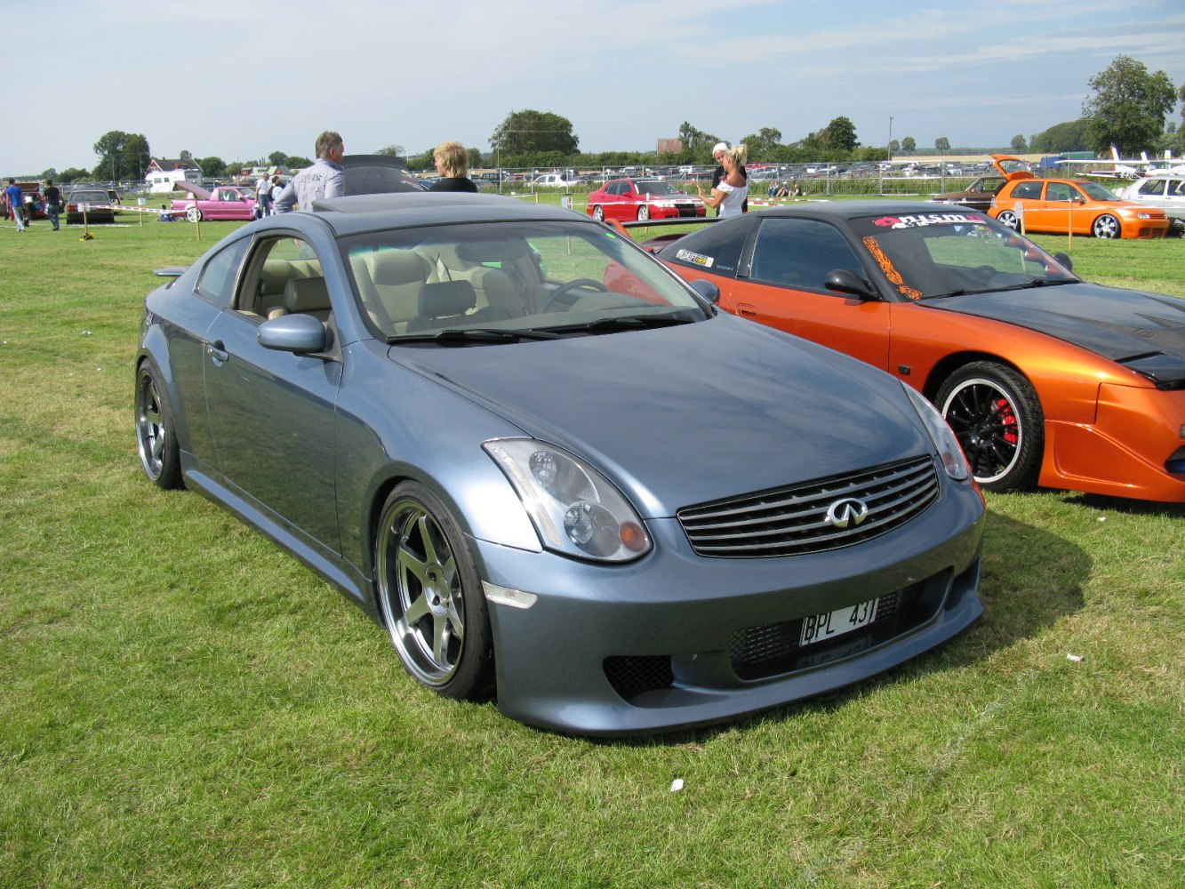 Front angle lowered sports coupe with custom alloy wheels and aerodynamic body kit