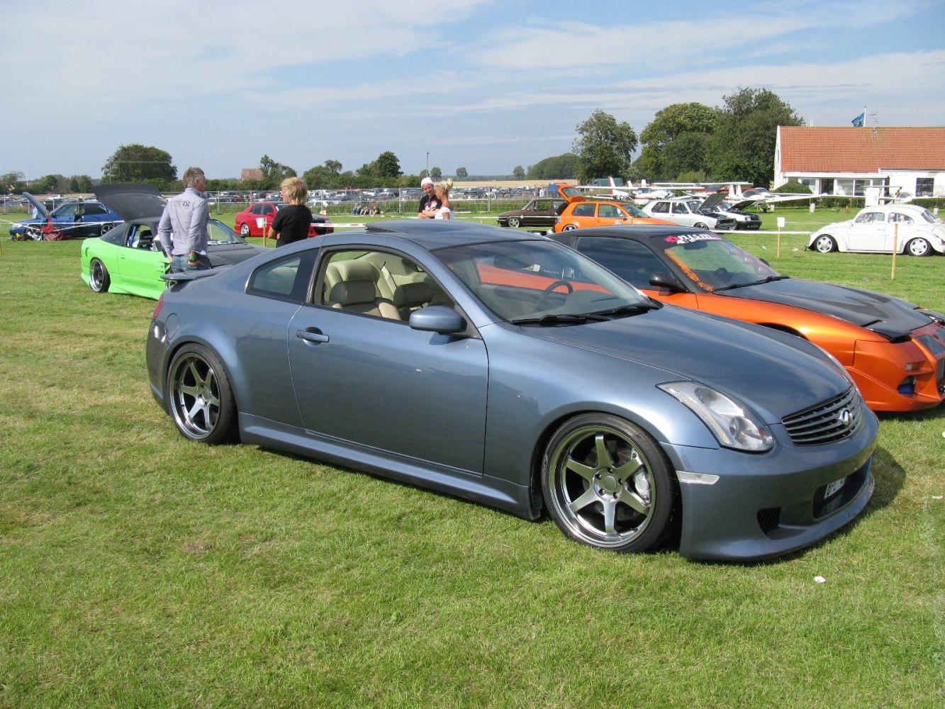 Blue sporty coupe with lowered stance and wide alloy wheels