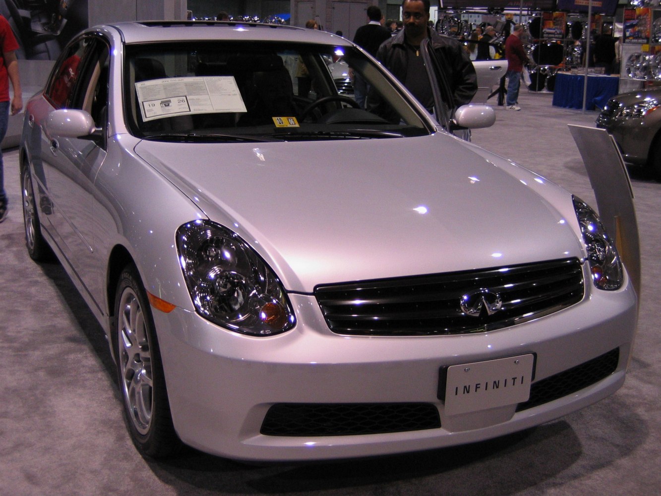 Front view of sedan with sleek headlights and signature grille