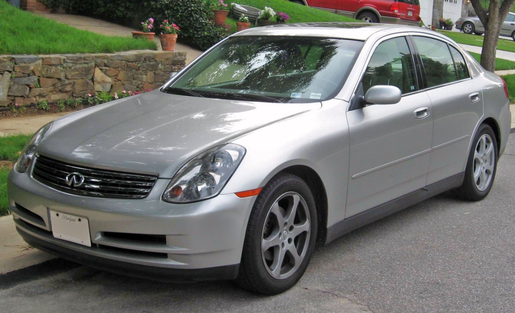 Silver sedan with sleek rounded headlights and five-spoke alloy wheels