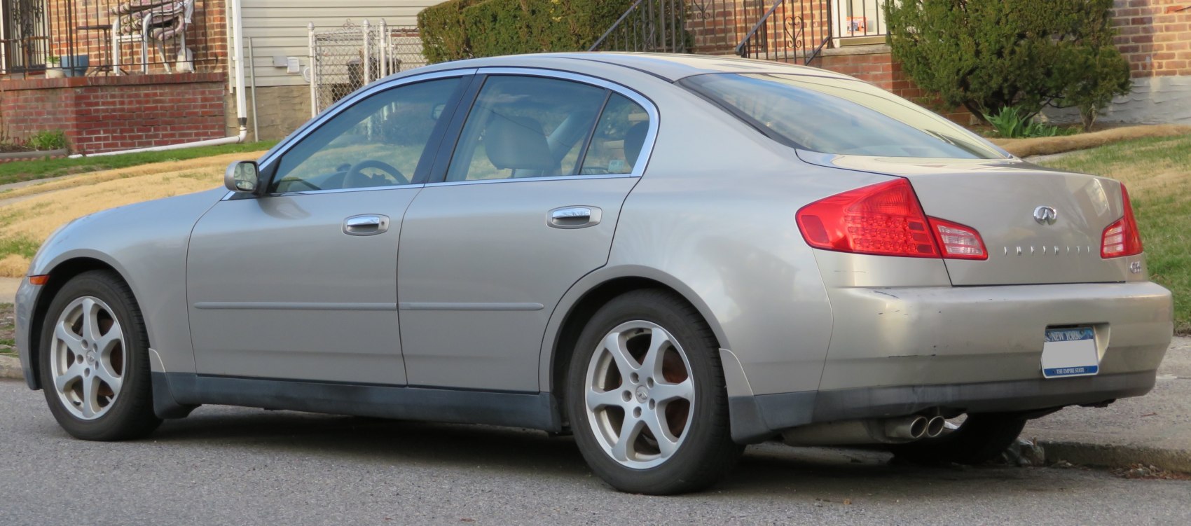 Silver 4-door sedan rear side view with distinctive tail lights