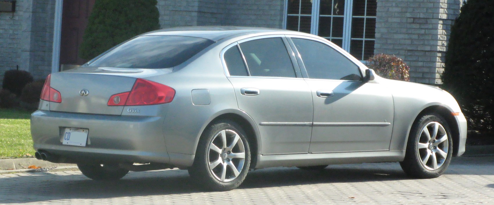 Silver sedan rear and side profile with alloy wheels.